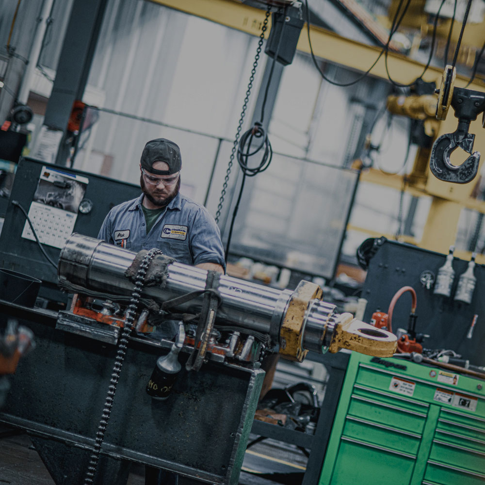 employee working on a cylinder