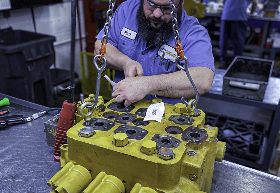 employee working on a large pump in the pump shop